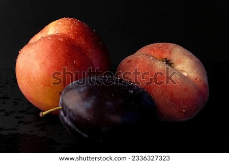 Ripe plum and nectarines with water drops