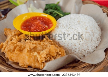 Chicken crispy with spicy sauce, vegetables and rice. The photo is suitable to use for food background, poster and food content media.
