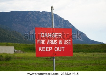 danger firearms in use sign Royalty-Free Stock Photo #2336364915