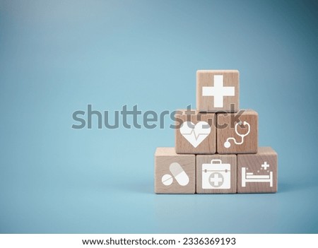 Wooden cube blocks stacked with icons. Health and Medicine Concepts.