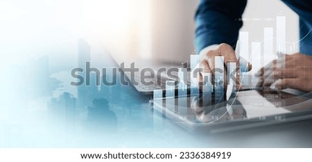 finance with a professional businessman use using laptop and tablet analyzing financial data, graph growth chart in action. perfect business plan, strategy, and solution. Royalty-Free Stock Photo #2336384919