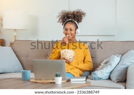 African American teenage  women sitting on sofa relax enjoying meditation for sleep and peaceful mind in wireless headphones at home. Royalty-Free Stock Photo #2336388749