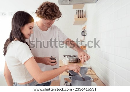 Love couple cooking food in kitchen for breakfast morning Happiness Smile couple help cooking together at home Spending time together in kitchen Lovely girlfriend and boyfriend enjoy cooking get fun Royalty-Free Stock Photo #2336416531