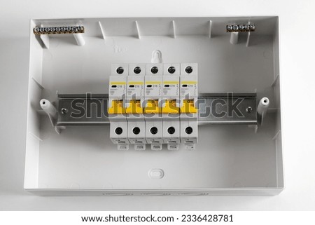 Plastic distribution board. Electrical board. Close-up. Isolated on light gray background. Royalty-Free Stock Photo #2336428781