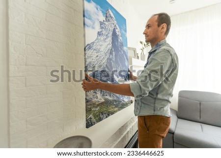 Waist up portrait of modern bearded man buying picture in art gallery, copy space