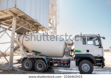 Concrete mixer truck loading concrete mortar Royalty-Free Stock Photo #2336465415
