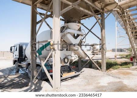 Concrete mixer truck loading concrete mortar Royalty-Free Stock Photo #2336465417