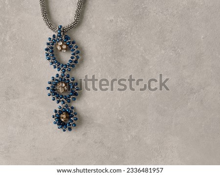 Elegant jewelry set ring, necklace and earrings with diamonds.Product still life concept. Modern and decorative textured background.