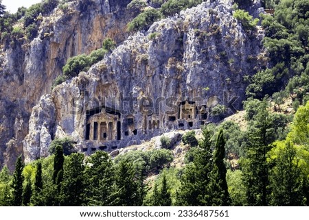 Rock-cut temple tombs in Kaunos  Mugla. Ancient city of Kaunos. Lycian style tomb. One of the important historical and touristic places of Turkey. Visible from Dalyan river. Grainy, noise photo.