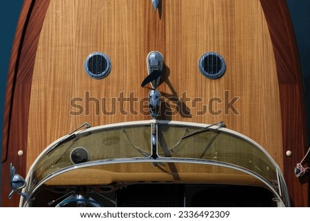 Helm boat. The front of a wooden boat on a blue background top view. Expensive wooden lacquered part of the boat. Fore deck. Wooden deck on a blue background top view. Royalty-Free Stock Photo #2336492309