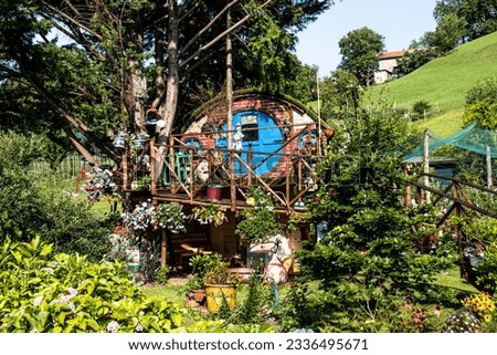 Colorful magic tree house in the nature. Fairy Tail for children and adults reminds house of hobbits.