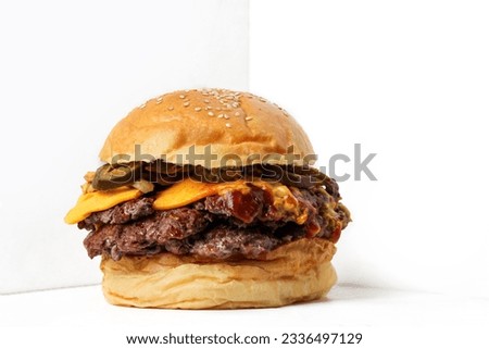 Classic Double beef smash burger with jalapeno on white background  Royalty-Free Stock Photo #2336497129