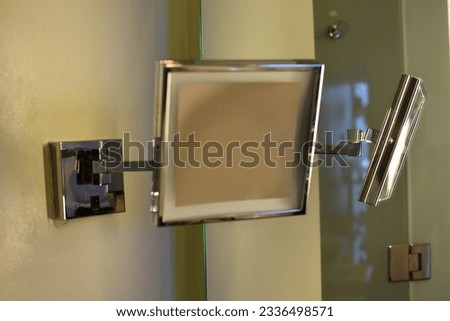 Square decorative wall mirror for makeup.