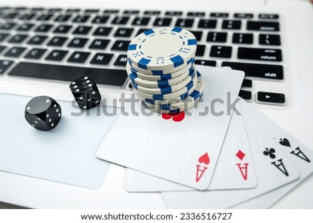 Business online poker games with laptop two black dice playing card and casino chips. Gambling concept Royalty-Free Stock Photo #2336516727