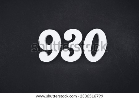 Black for the background. The number 930 is made of white painted wood.