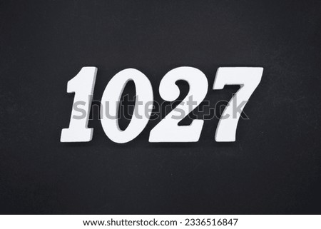 Black for the background. The number 1027 is made of white painted wood.