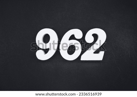 Black for the background. The number 962 is made of white painted wood.