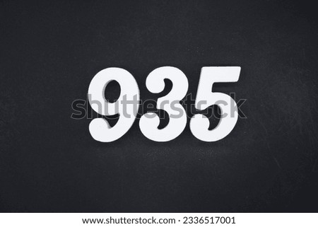 Black for the background. The number 935 is made of white painted wood.