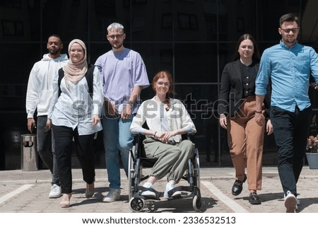 A diverse and confident group of young businessmen poses together, with businesswoman in wheelchair radiating success, ambition, and unity, capturing the essence of a dynamic and inspiring business