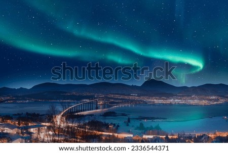 Aurora borealis or Northern lights in the sky over Tromso with Sandnessundet Bridge - Tromso, Norway Royalty-Free Stock Photo #2336544371