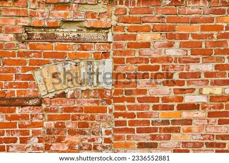 Split wall of regular red bricks versus decaying wall of mismatching bricks background asset