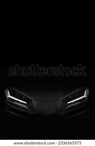 Silhouette of black sports car with LED headlights on black background	 Royalty-Free Stock Photo #2336565573