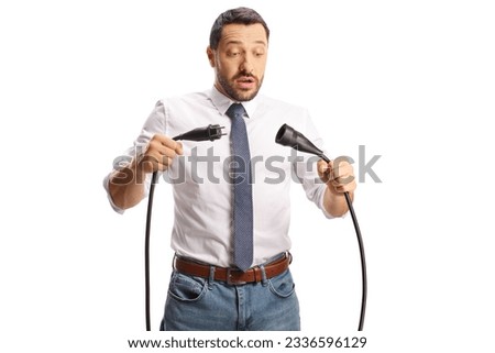 Young man unplugging cables isolated on white background Royalty-Free Stock Photo #2336596129