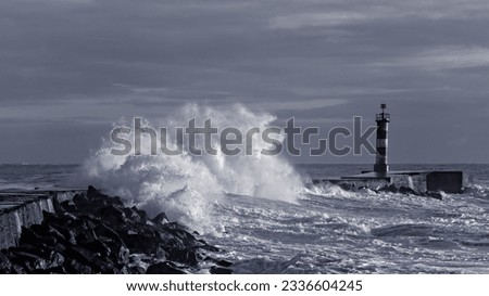 Sea storm at winter sunset. North of Portugal. Black and white toned blue.