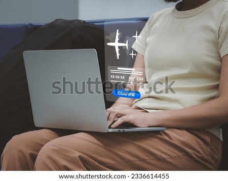 young woman confirming flight booking Confirm your trip with the airline. through an application on a laptop Royalty-Free Stock Photo #2336614455