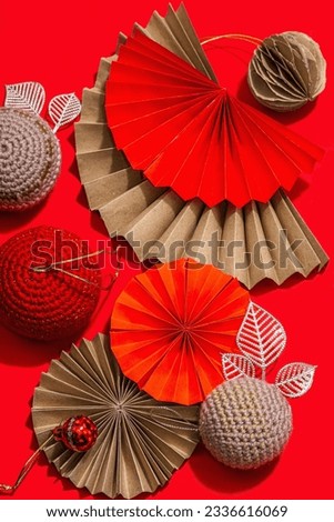 Happy Chinese New Year concept. Oriental asian style paper fans, traditional decor on red background, minimal concept, flat lay, top view