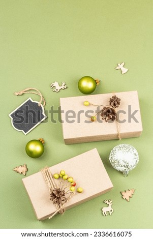 Zero waste gift concept. Handcrafted eco style, natural New Year, Thanksgiving, Christmas decoration. Kraft paper wrapping without plastic. Trendy Savannah Green color background, flat lay, top view
