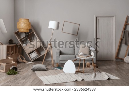 Sofa with tables and shelving units in messy living room Royalty-Free Stock Photo #2336624339