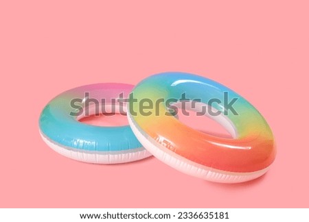 Inflatable rings on pink background Royalty-Free Stock Photo #2336635181