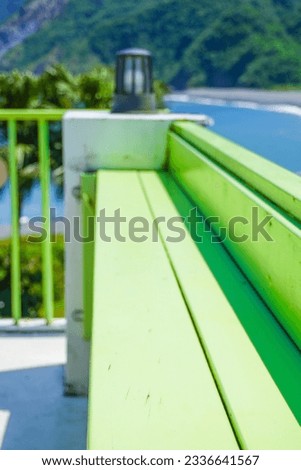 Harbor Photography - Green benches with a mountain behind them