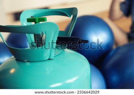 helium tank with balloons. Inflating balloons with helium at home. Balloons do not fly, various problems when inflating balloons with helium Royalty-Free Stock Photo #2336642029