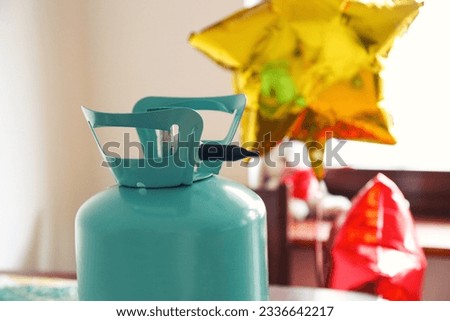 helium tank with balloons. Inflating balloons with helium at home. Balloons do not fly, various problems when inflating balloons with helium Royalty-Free Stock Photo #2336642217
