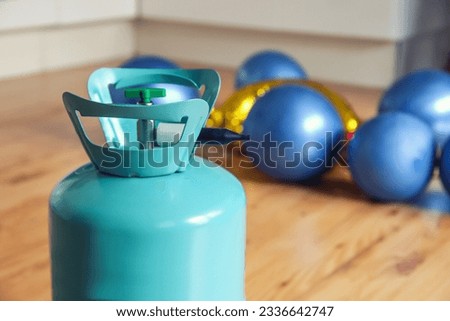 helium tank with balloons. Inflating balloons with helium at home. Balloons do not fly, various problems when inflating balloons with helium Royalty-Free Stock Photo #2336642747