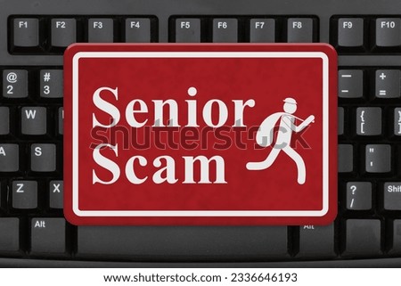 Senior Scam message on red sign on a keyboard