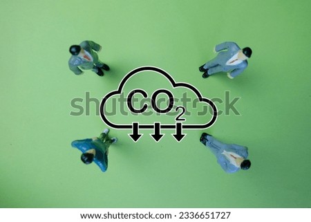 Reduce CO2 emission,Carbon dioxide emissions,renewable energy concept.,Team of Businessman Standing in Circle,Focusing on the Center with Reduce CO2 icon over green background.