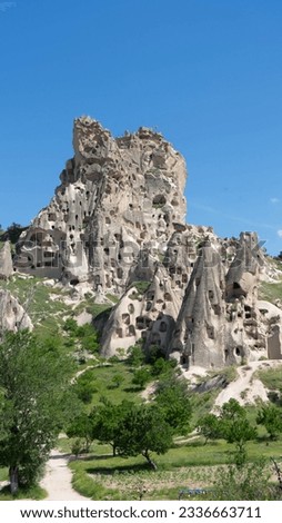Portrait picture of caves in the volcanic mountain formations of the Cappadocia in Turkey near Goreme