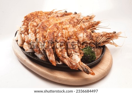 Sizzling Grilled prawn (Shrimp) Is a popular Italiyan - continetal delicacy all over Japanese. Arabic, Chinese cuisine pictures, isolated on White background. Royalty-Free Stock Photo #2336684497