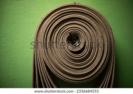 Fire hose on wall. Hose for extinguishing fire. Security features in building. Fire equipment.