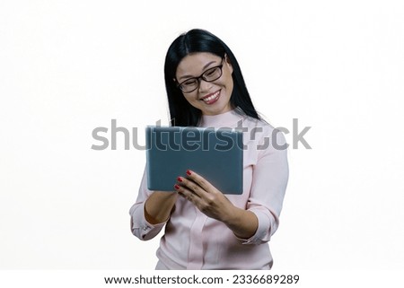 Young smiling asian businesswoman having online conversation via tablet pc. Cheerful korrean nerdy girl with modern device. Isolated on white background.