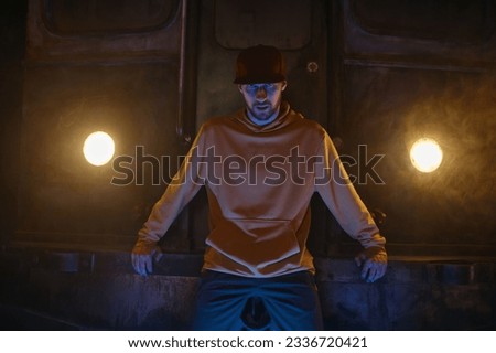 Portrait of breakdancer preparing for performance standing in smoke