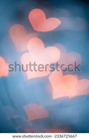 Abstract bokeh background, love and romance concept, natural flare from lights as hearts on blue, vertical photo, optical effect, blurred bokeh texture as holiday backdrop, celebration screensaver