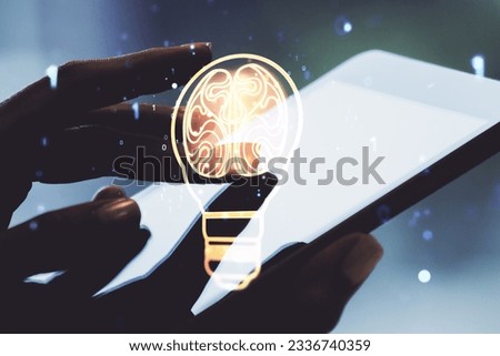 Creative light bulb with human brain hologram and hand working with a digital tablet on background, artificial Intelligence and neural networks concept. Multiexposure