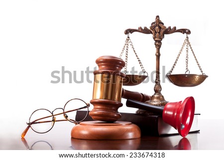 Antique bronze scales, gavel, book, bell and glasses on a white background
