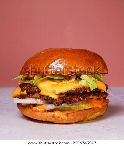 smash burger with cheddar cheese  Royalty-Free Stock Photo #2336745547
