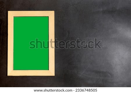 wooden photo frame inside in green screen on dark background. copy space for text and pictures.  
