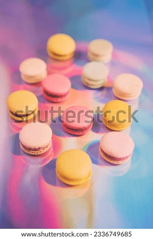 French cake macaron. Set of cute sweets on colorful rainbow background. almond cookies, pastel colors, top view